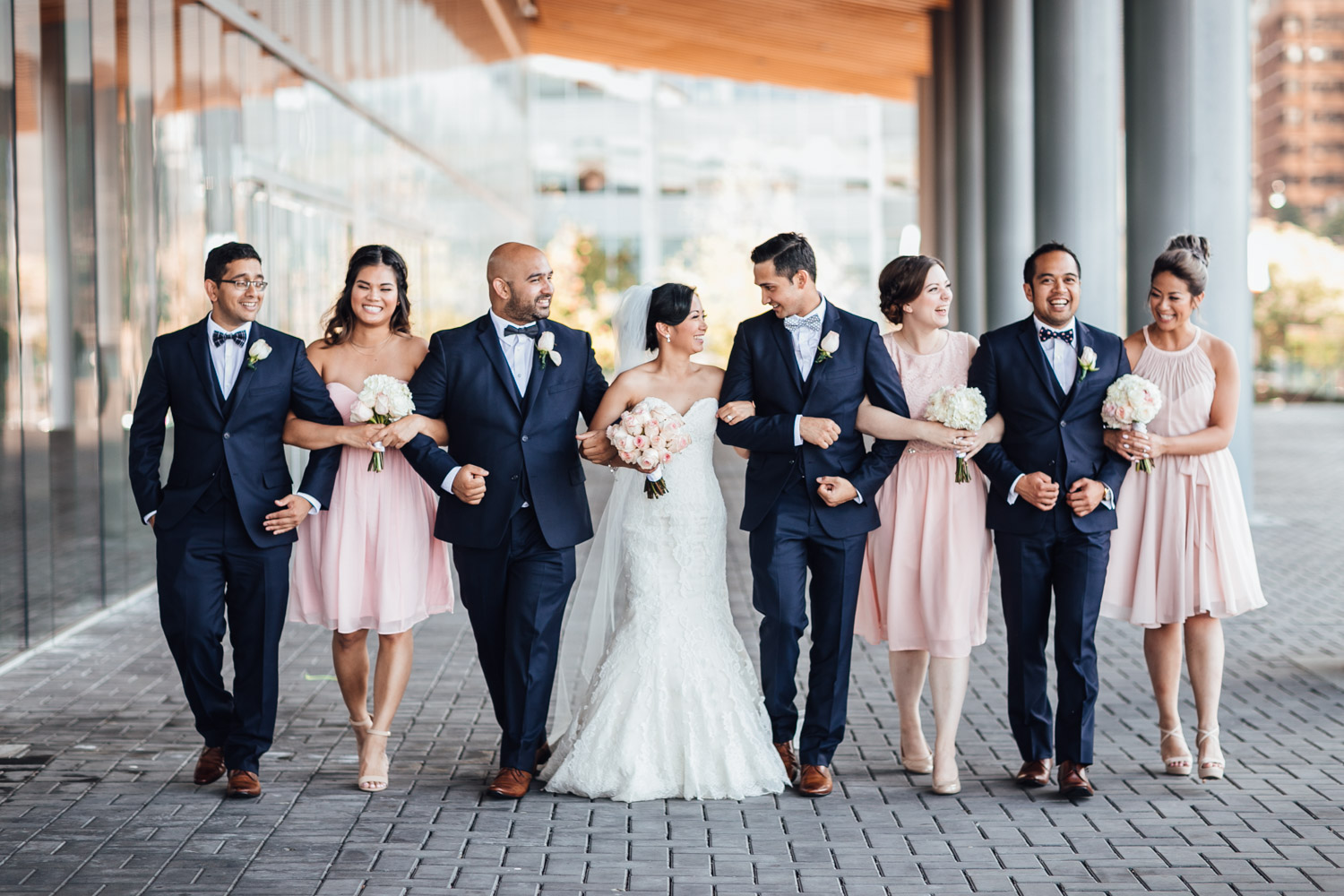 bridal party walking candid at vancouver convention centre wedding in coal harbour bc
