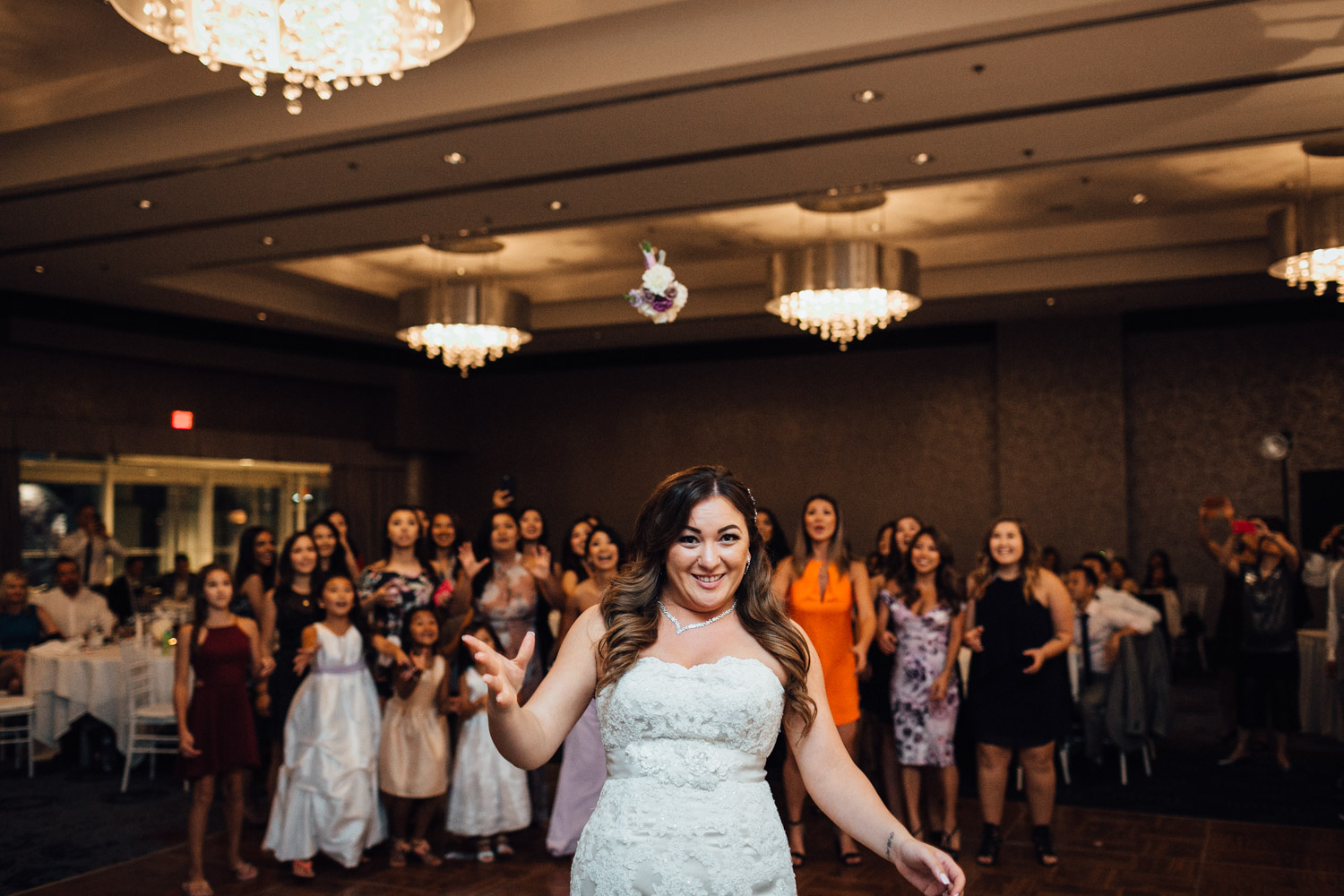 bouquet toss wedding reception photography in north vancouver pinnacle at the pier