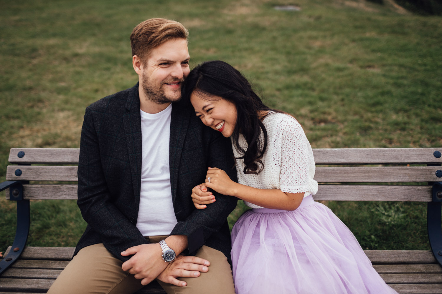 north vancouver couple sitting on bench laughing candid engagement photography pinterest