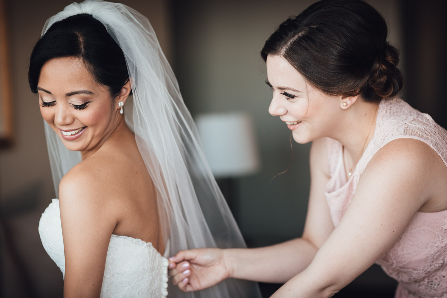 zipping up bridal dress wedding in vancouver at holiday inn