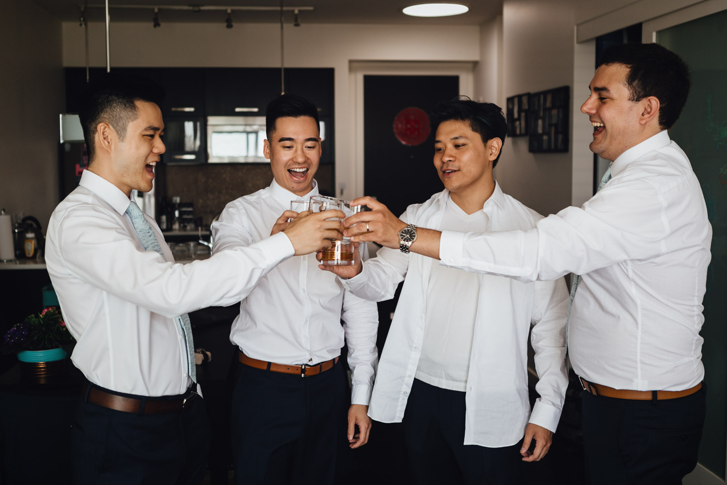 groom and groomsmen cheers alcohol vancouver getting ready wedding photography