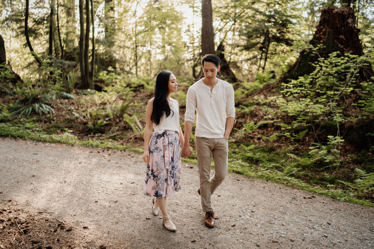 walking candid in stanely park forest engagement photography vancouver bc