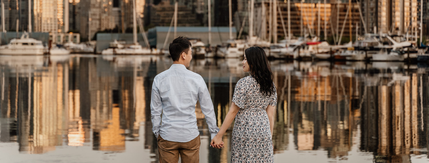 stanley park engagement photography in vancouver bc during sunset or golden hour skyline view